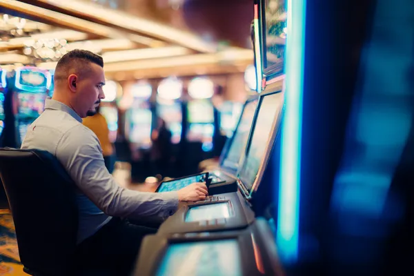 A young woman relaxing with her phone while dynamic casino elements float around her, illustrating the smooth mobile experience offered by the SAGISAGPH app.
