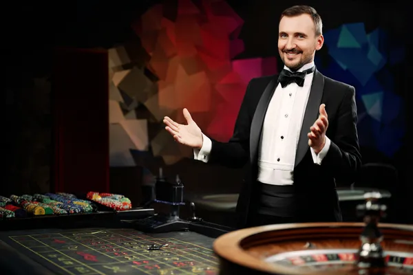 A glowing roulette wheel with cascading chips, symbolizing the engaging live and instant-win games available on SAGISAGPH.